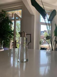 a glass container sitting on top of a table at Stylish 3-bdrm apt. w/ terraces next to the beach in The Hague