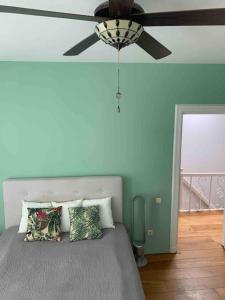 a bedroom with a bed with a ceiling fan at Stylish 3-bdrm apt. w/ terraces next to the beach in The Hague