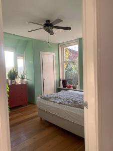 a bedroom with a bed and a ceiling fan at Stylish 3-bdrm apt. w/ terraces next to the beach in The Hague