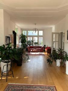 a living room filled with lots of potted plants at Stylish 3-bdrm apt. w/ terraces next to the beach in The Hague