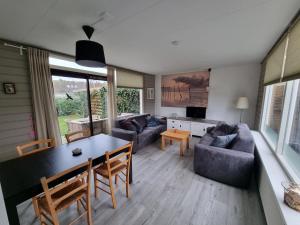 a living room with a table and a couch at Zilt Zand in De Koog