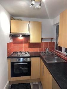 a kitchen with a stove and a sink at City Escape! Fishponds Apartment, Bristol, sleeps up to 4 guests in Bristol