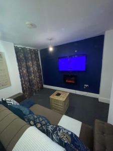 a living room with a couch and a flat screen tv at City Escape! Fishponds Apartment, Bristol, sleeps up to 4 guests in Bristol