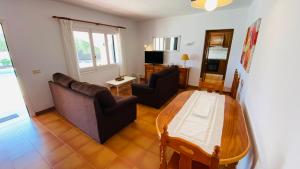 a living room with a couch and a table at Villa Neus in Sant Climent