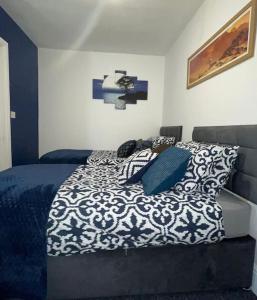 a bedroom with a blue and white bed with pillows at City Escape! Fishponds Apartment, Bristol, sleeps up to 4 guests in Bristol