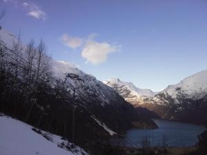 a view of a snow covered mountain with a lake at Lunheim in Geiranger in Geiranger