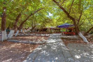 a walkway in a park with trees and a building at Fodele Beachfront Apts in Fodele
