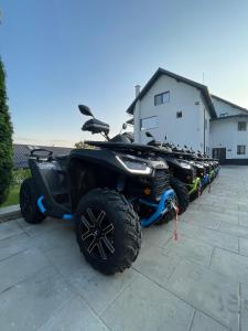 a row of atvs parked in front of a building at Casa YDA in Horezu