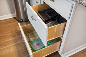 an open drawer in a kitchen cabinet at Historic + Pet-Friendly Gem in Bay City
