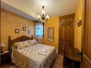 a bedroom with a bed with two towels on it at El Sobrao de Gredos in Navarredonda de Gredos