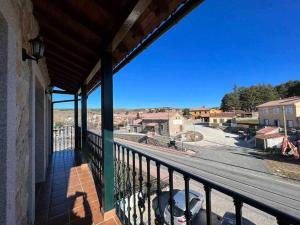 a balcony of a building with a view of a street at El Sobrao de Gredos in Navarredonda de Gredos