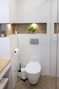 a bathroom with a toilet and a glass shower at Apartment Eliya - FREE GARAGE & 15 min to the beach in Varna City