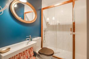 a bathroom with a toilet and a sink and a mirror at LUXa Charm House by LovelyStay in Sintra