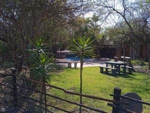 a park with a bench and a picnic table at Bellamia in Marloth Park