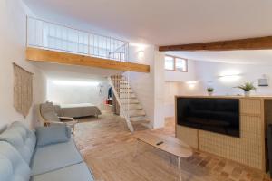 ein Wohnzimmer mit einem Sofa und einem TV in der Unterkunft Casa Montesa in Vilafames