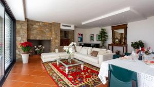 a living room with a white couch and a fireplace at Villa degli Angeli in Soiano del Lago