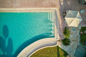 an overhead view of a swimming pool with an umbrella and an umbrella at Ionian Aura in Tsilivi