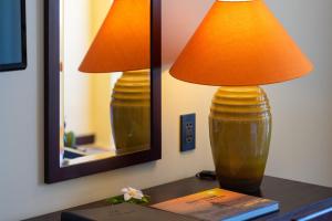 a lamp sitting on a table next to a mirror at Pandanus Resort in Mui Ne