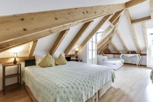 a bedroom with a large bed and wooden ceilings at LUXa Charm House by LovelyStay in Sintra +43 photos