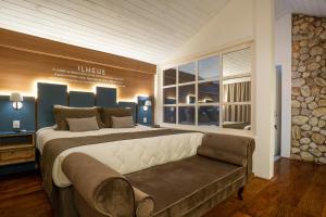 una grande camera da letto con un grande letto e un divano di Casa Sabor Chocolate a Campos do Jordão