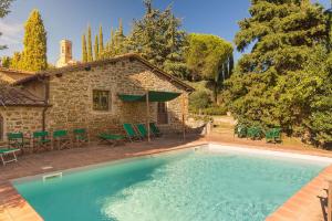 a large swimming pool in front of a house at Pozza di Volpaia by Salogi Villas in Radda in Chianti