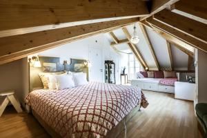 a bedroom with a bed with a red comforter at LUXa Charm House by LovelyStay in Sintra