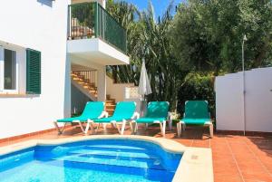 a group of chairs and a swimming pool at Villa Toymi in Ciutadella