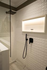 a bathroom with a shower with a shower head at Cape Village Lodge in Durbanville