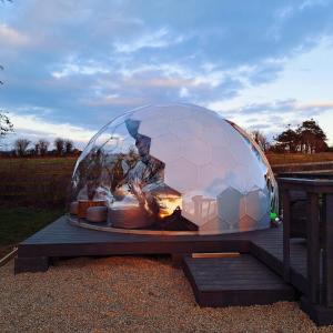 a large ball on a table with food in it at Luxury Glamping Dome with views of the Burren in Boston