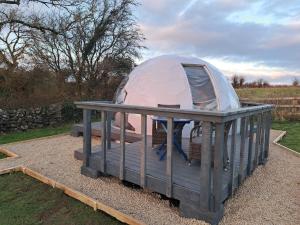 a dome tent on a wooden platform in a yard at Luxury Glamping Dome with views of the Burren in Boston