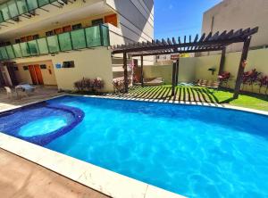 a swimming pool in front of a building at Flat Manawa Beach - Porto de Galinhas in Porto De Galinhas