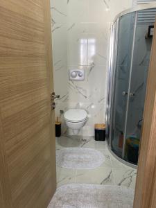 a bathroom with a toilet and a glass shower at Private Room in Istanbul #39 in Istanbul
