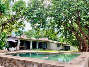 a house with a swimming pool in front of it at Mitengo House in Lilongwe