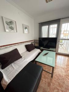 a living room with a couch and a table at La Oliverica in Caudete