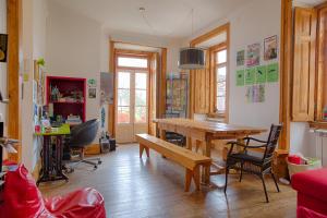 a living room with a wooden table and chairs at This Is Lisbon Hostel in Lisbon
