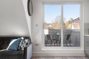 a living room with a sliding glass door with a table and chairs at Flat 5 - Star London Vivian Lane 2-Bed Residence in The Hyde