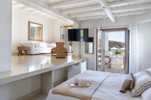 a bedroom with a bed and a living room at Elies Resorts in Vathi
