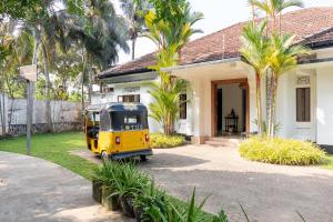 a small yellow van parked in front of a house at Lotus Surf And Wellness in Ahangama