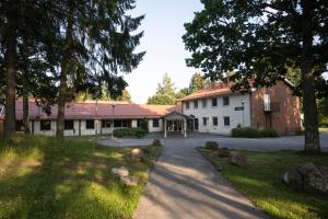 eine Straße, die zu einem weißen Gebäude mit Bäumen führt in der Unterkunft Lundsbrunn Resort & Spa in Lundsbrunn