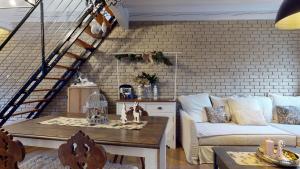 a living room with a couch and a table at LE NID DE L'ILL, Magnifique Duplex Cosy Petite France in Strasbourg