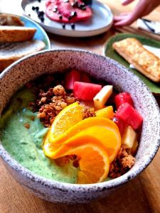 a bowl of food with fruit and nuts on a table at Elements Hotel & Shops Curaçao in Willemstad