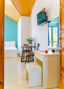 a kitchen and living room with a table and a chair at AN Boutique Hotel - STAY 24H in Da Lat