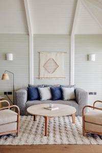 a living room with a couch and a coffee table at Soho Beach House Canouan in Canouan