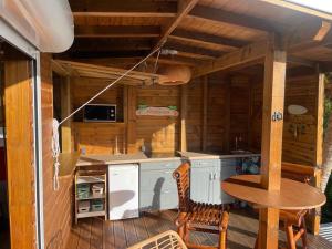 a kitchen in a cabin with a table and chairs at KAZAKOLIBRI in Gourbeyre