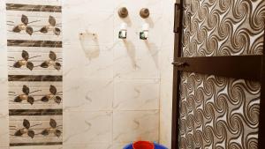 a bathroom with a door and a wall with some towels at NOOR Inn & Guest House -Couples Favorite,Local ID Accepted -- High Rated by Couples in Jalandhar