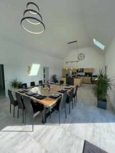 a large dining room with a long table and chairs at TY MENEZ HEOL - Magnifique villa avec piscine in Ploudalmézeau +44 photos