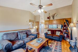 a living room with a couch and a table at Holiday Island Overlook in Eureka Springs