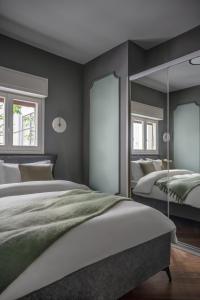 a bedroom with two beds and a mirror at Unique & Upscale Gem in Tel Aviv