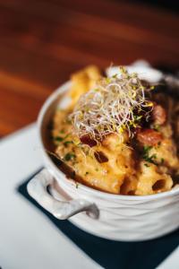 a bowl of food on a plate on a table at Elements Hotel & Shops Curaçao in Willemstad