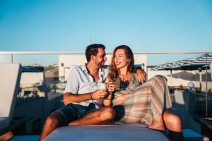 a man and a woman sitting on a boat at Elements Hotel & Shops Curaçao in Willemstad